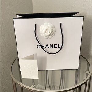 CHANEL White Gift Bag with Embossed Floral Accent